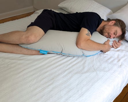 A man hugs a Sleep Pillow