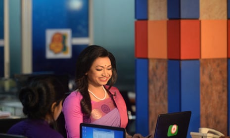 Tashnuva Anan Shishir presents the news at a news studio in Dhaka