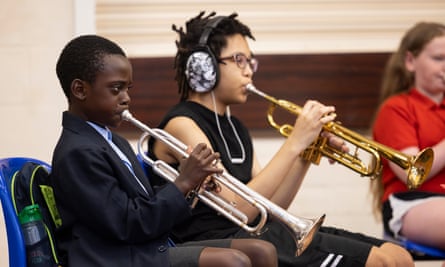 Emmanuel playing into a silver horn