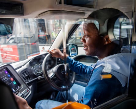 Bahrain Mujagata at the wheel of his black cab – with the photograph taken from the passenger’s seat