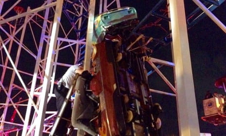 Daytona Beach firefighters are working to rescue two roller coaster riders that are in a dangling rollercoaster car when their car derailed on the Daytona Beach, Florida, boardwalk on June 14, 2018 in this Daytona Beach Fire Department photo. Courtesy Daytona Beach Fire Department/Handout via REUTERS ATTENTION EDITORS - THIS IMAGE HAS BEEN SUPPLIED BY A THIRD PARTY.