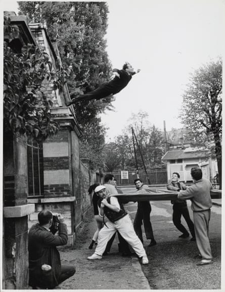 Yves Klein leaping off a roof in Paris, 1960, into a tarpaulin held by men below