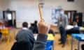 A pupil raises their hand during a lesson at Whitchurch high school in Cardiff, Wales, 2021.