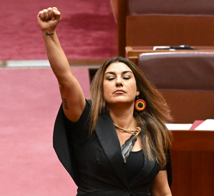 Lidia Thorpe raises her arm during her swearing-in ceremony in the Senate chamber at Parliament House.