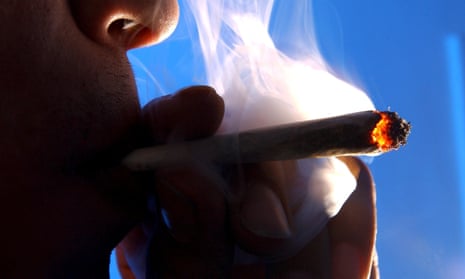 a closeup of a person smoking a marijuana joint