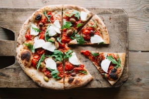 Sliced pizza on chopping board
