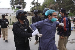 A policeman arrests a doctor during the protest in Quetta, after medical staff tried to enter the home of the local chief minister