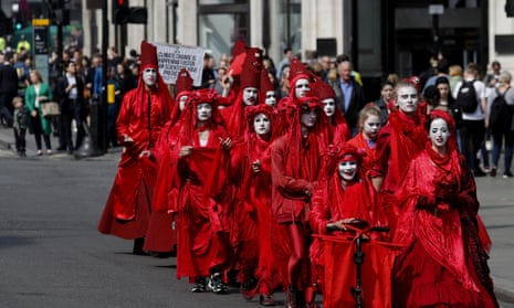 Members of the so called ‘Red Brigade’ march from Oxford Circus to Piccadilly Circus in London in protest against inaction over climate change
