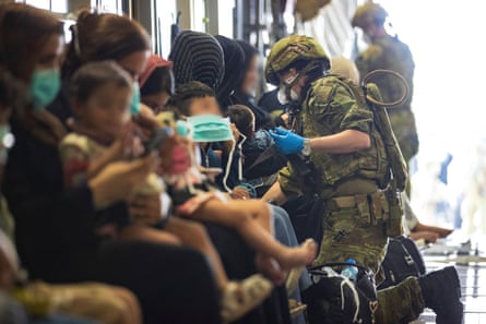 The Royal Australian Air Force Air assist Afghanistan evacuees prior to departing the airport in Kabul on 22 August.