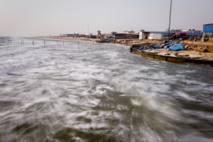 Waves crash against the shoreline of the abandoned Dawanggang holiday resort, Hebei province