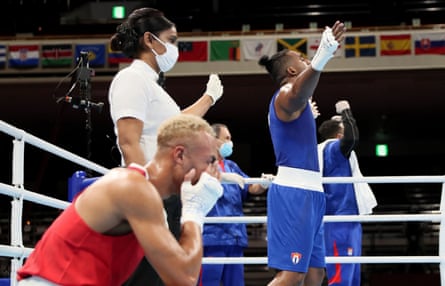 Ben Whittaker (left) and Arlen López react to the judge’s decision in the gold-medal bout.