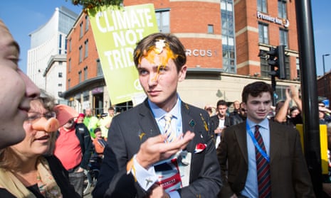 A Conservative delegate is hit by an egg at an anti-austerity march in Manchester as the party conference opened.