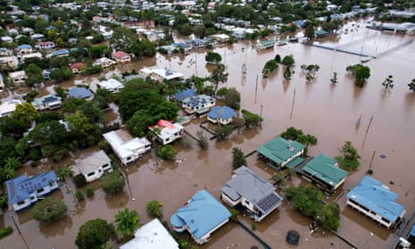 An aerial view of houses surrounded by floodwater in Lismore, Australia