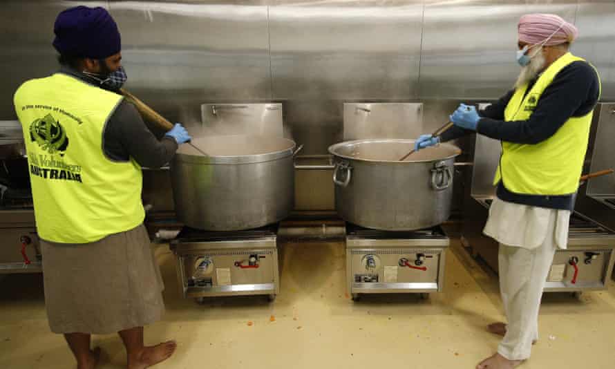 Volunteers stir pots at a Sikh Volunteers Australia-run kitchen in Melbourne