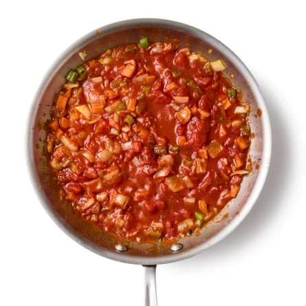 Felicity Cloake’s Portuguese feijoada 04c. Once the beans are ready, we drain them, retaining the cooking water but discarding the onion halves and bay leaves. Add the beans and pork to the vegetable pan, then pour over enough bean liquor to cover (keep any excess for now) and bring to a simmer.