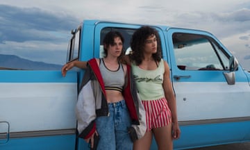 Kristen Stewart and Katy O’Brian leaning against a pick-up.