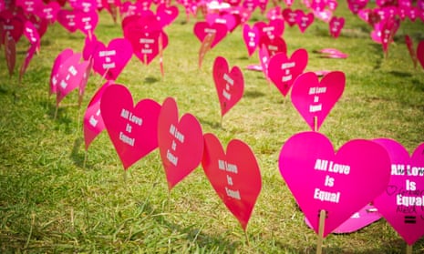 Heart-shaped signs printed with the message 'all love is equal'