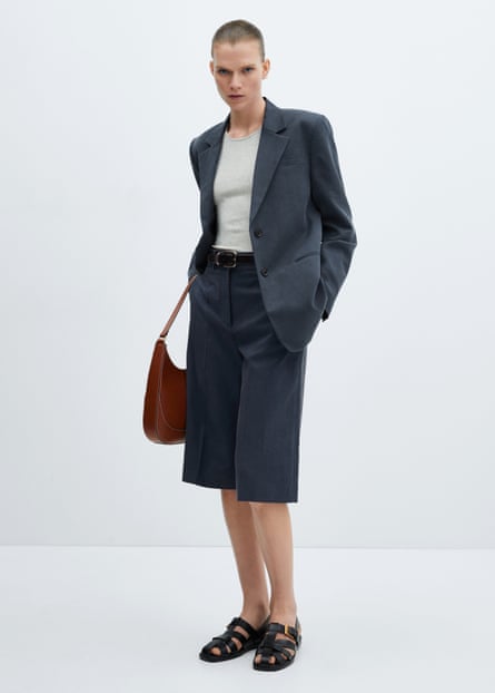 Model wearing Bermuda shorts matching blazer