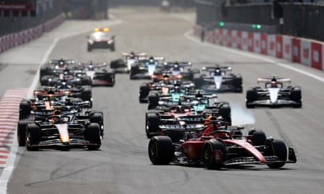 Charles Leclerc of Ferrari leads the pack at the start of the race.