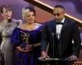 Andy Mundy-Castle (right) speaks on stage while accepting a Bafta
