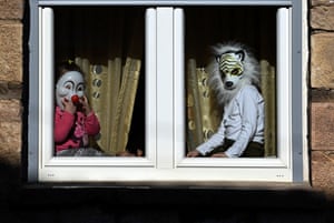 Vevcani, MacedoniaChildren wear masks as they watch a carnival procession from a window. The carnival is held to celebrate the New Year according to the Julian calendar. The festivity is held on 13 and 14 January every year. People in Vevcanci believe that with their masks they banish evil spirits from their lives