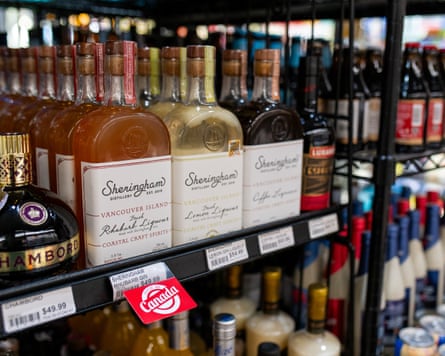 A red label marked ‘Canada’ sticking out beneath a row of whiskey bottles