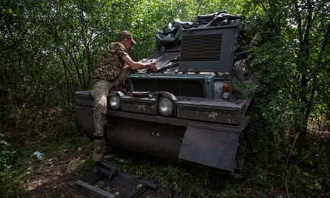 A Ukrainian serviceman repairs an armoured personnel carrier in the Donetsk region on Sunday