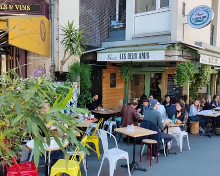 Diners sit outside the Chez les Deux Amis Brocante restaurant.