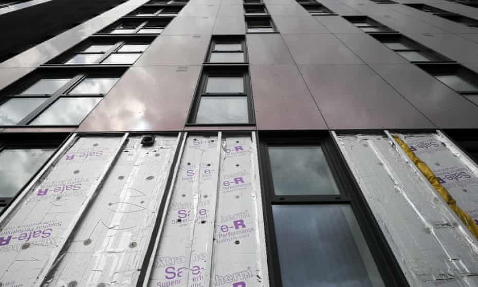 Cladding is removed for testing from one of the tower blocks in Salford City