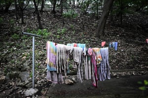 Towels and clothing hang on a clothesline outside of a cabin
