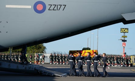 Pallbearers from the Queen's Colour Squadron of the Royal Air Force carry the coffin of Queen Elizabeth II, draped in the Royal Standard of Scotland, into an aircraft at Edinburgh airport.