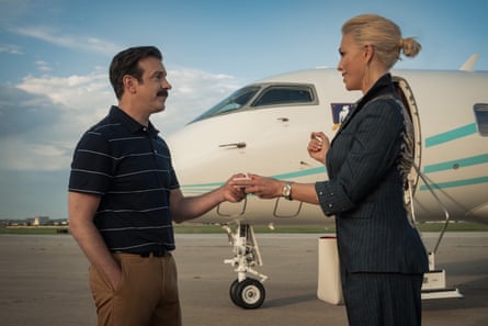 With Jason Sudeikis in Ted Lasso. They are shaking hands in front of a private plane.