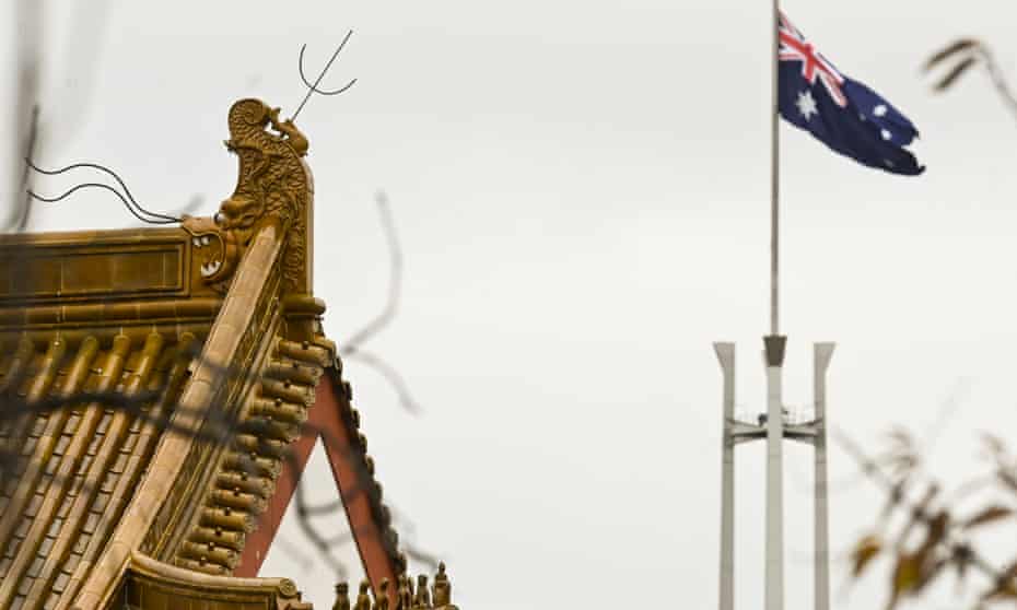 The flag pole of the Australian Parliament is seen behind the roofs of the Chinese Embassy in Canberra,