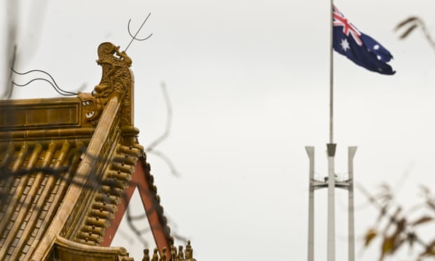 The flag pole of the Australian Parliament is seen behind the roofs of the Chinese Embassy in Canberra, 