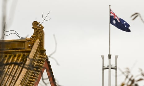 The flag pole of the Australian Parliament is seen behind the roofs of the Chinese Embassy in Canberra, 