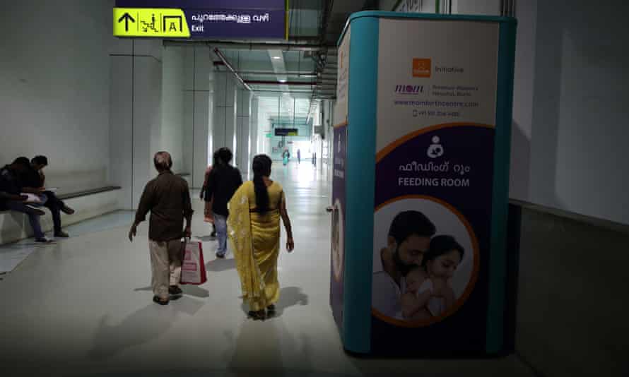 Passengers walk past a breastfeeding pod at Aluva metro station in Kochi