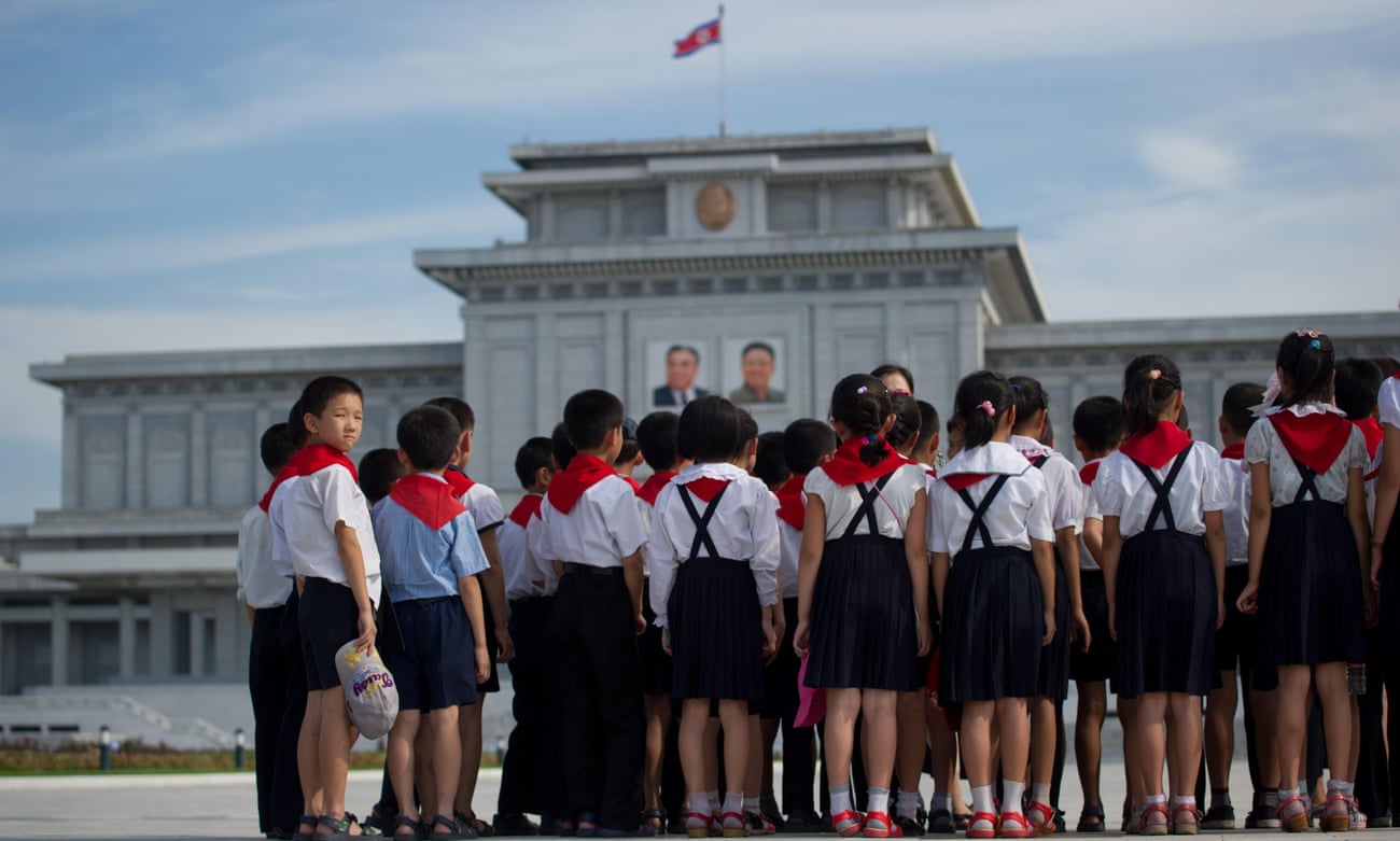 North Korean school children stand before the portraits of Kim Il-sung and Kim Jong-Il at the Kumsusan Palace of the Sun mausoleum in Pyongyang.