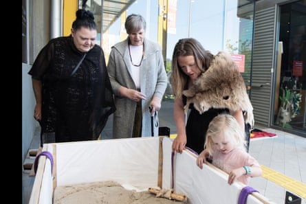 Trudy Maluga et Aunty Nola Hooper avec Rebecca Digney regardant dans une caisse d'emballage contenant l'une des sculptures