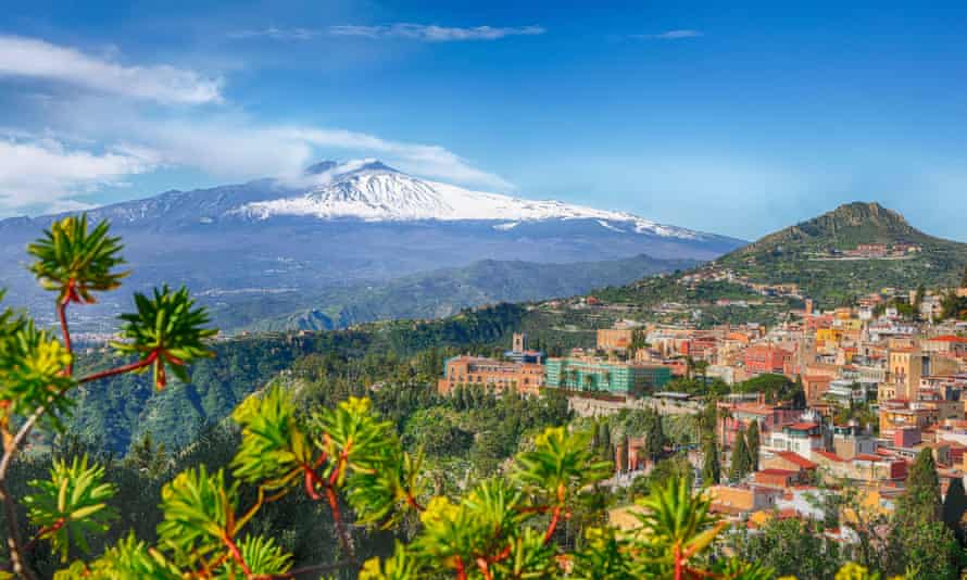 A panoramic view of Taormina with Mount Etna behind it