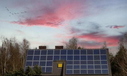Side view of large solar panel on roof at sunset