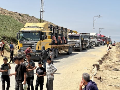 Trucks in the Nuseirat area of Gaza wait to transport aid supplies to be delivered through the temporary port, on Friday.