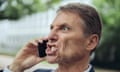 Portrait of angry businessman outdoors on the phone