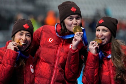 Valérie Maltais, Isabelle Weidemann and Ivanie Blondin with their gold medals after winning the final of the women’s team pursuit speedskating race at the 2026 Winter Olympics
