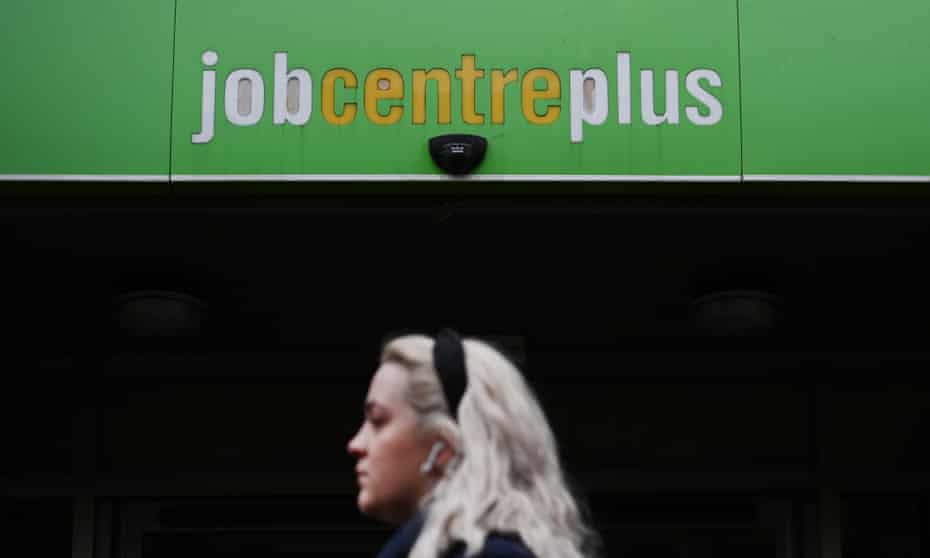 A pedestrian passes a jobcentre in London