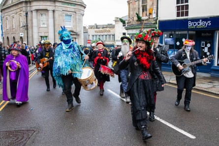 A band plays as they parade through Market Place.