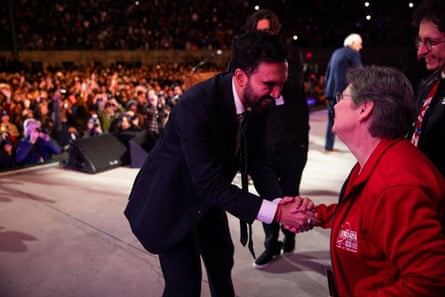 A man shaking a woman’s hand.