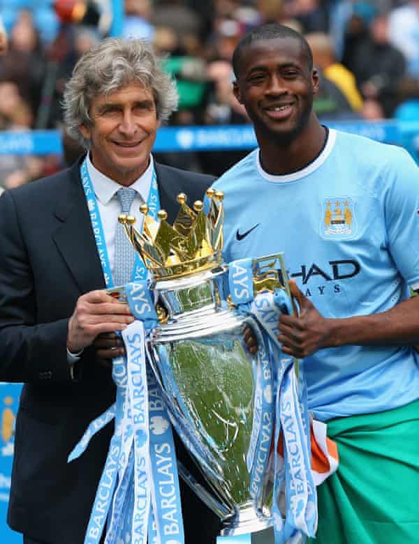 Manuel Pellegrini and Touré pose with the Premier League trophy in May 2014.