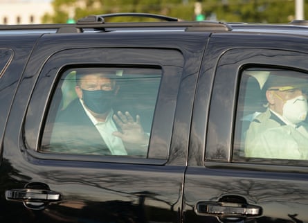 Donald Trump waves from the back of a car outside Walter Reed medical center in Bethesda, Maryland.