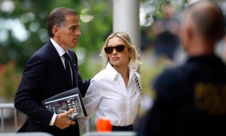 A man and a woman wearing a suit walk together