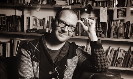 cory doctorow seated in an armchair in his office